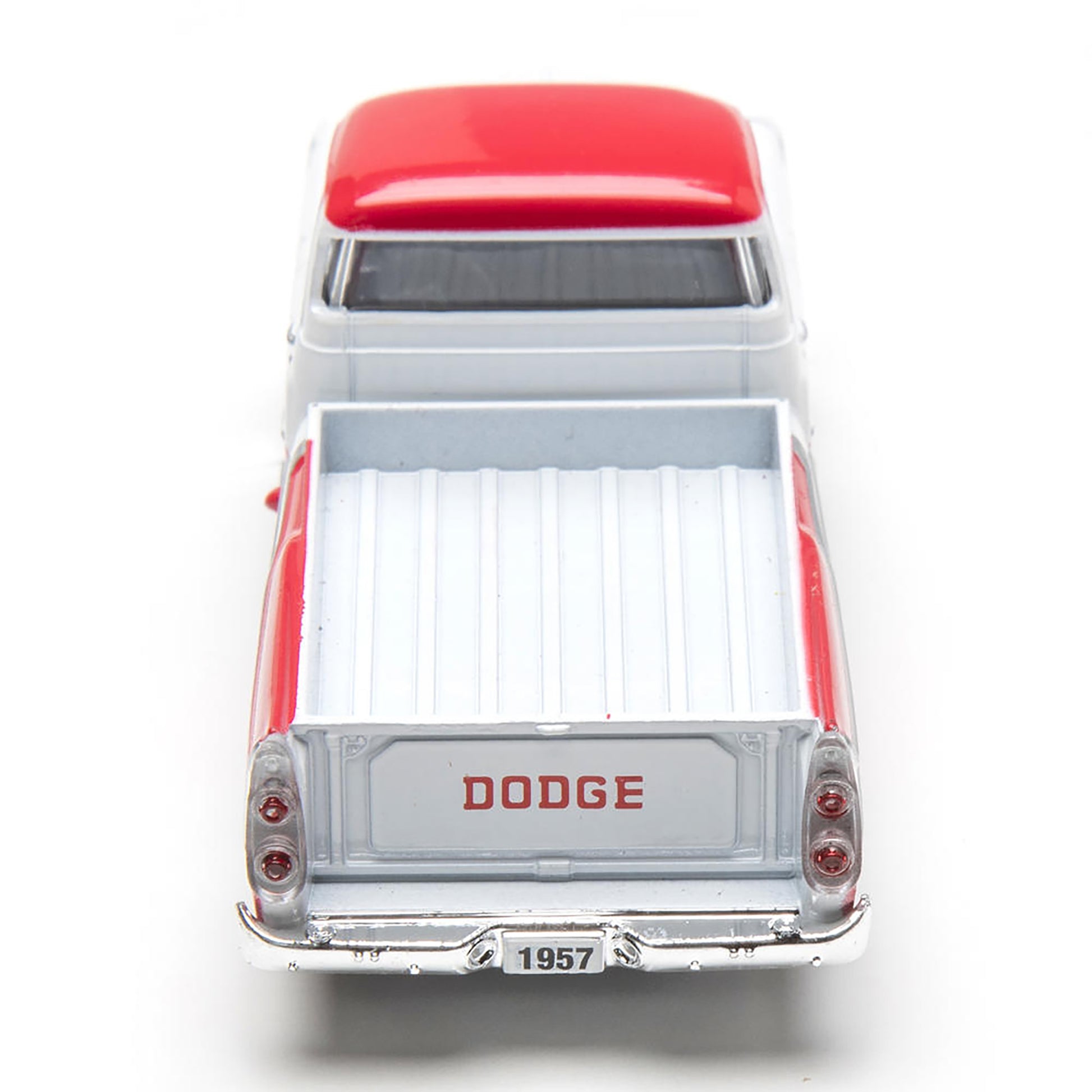 Model of a 1957 Dodge truck with a red roof on a white background