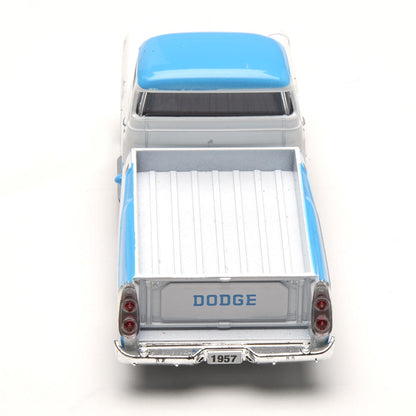 Model of a 1957 Dodge truck with a blue roof on a white background
