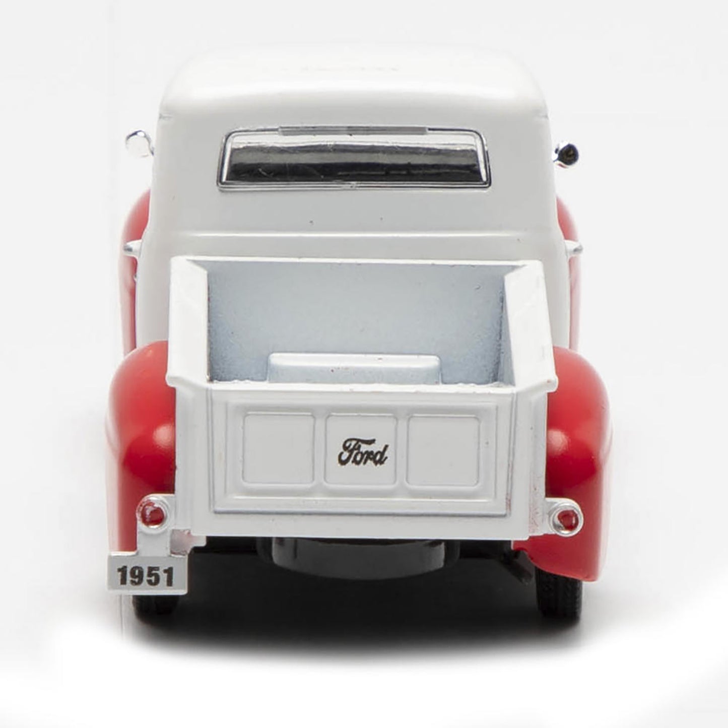 Model of a 1951 Ford truck with a white bed and red body on a white background