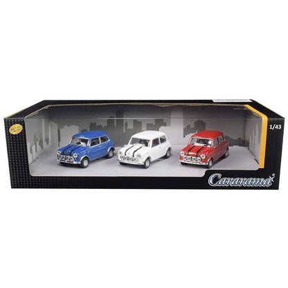 A 1/43 scale model car set of three Mini Coopers in blue, white, and red, presented inside a black windowed display box with the brand name 'Caramudi' visible on the front.