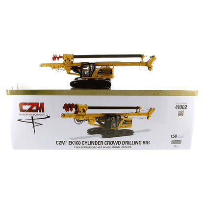Model of a Caterpillar 330 Next Gen Carrier with CZM EK160 Cylinder Crowd Drilling Rig Sitting on the Tin Box Packaging on a White Background