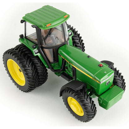 Model of a green John Deere 4960 tractor with yellow wheels on a white background