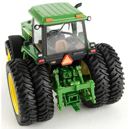 Model of a green John Deere 4960 tractor with yellow wheels on a white background