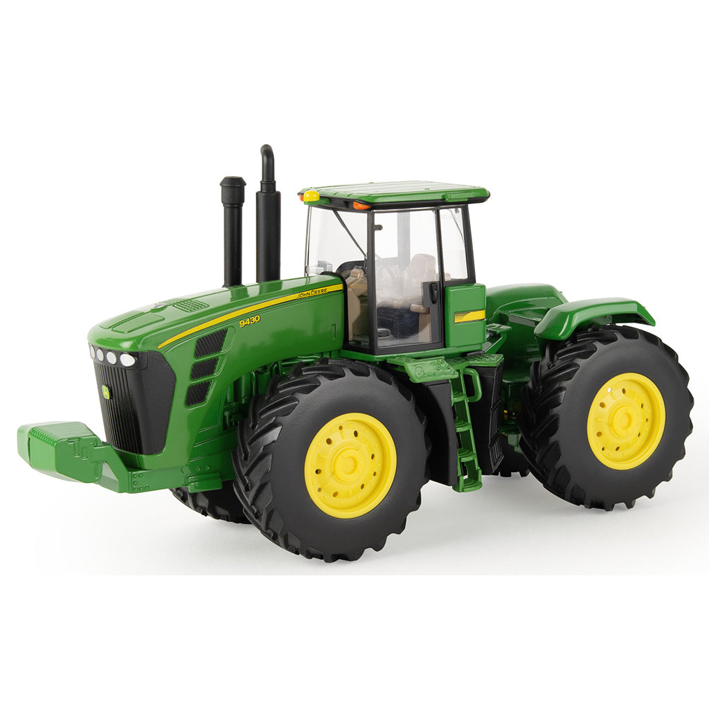 Green John Deere 9430 toy tractor with yellow wheels on a white background