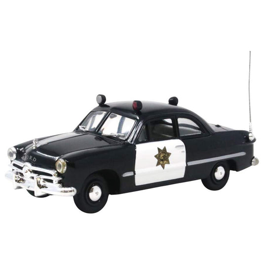 Model of a vintage police car with a white stripe and star emblem on a white background