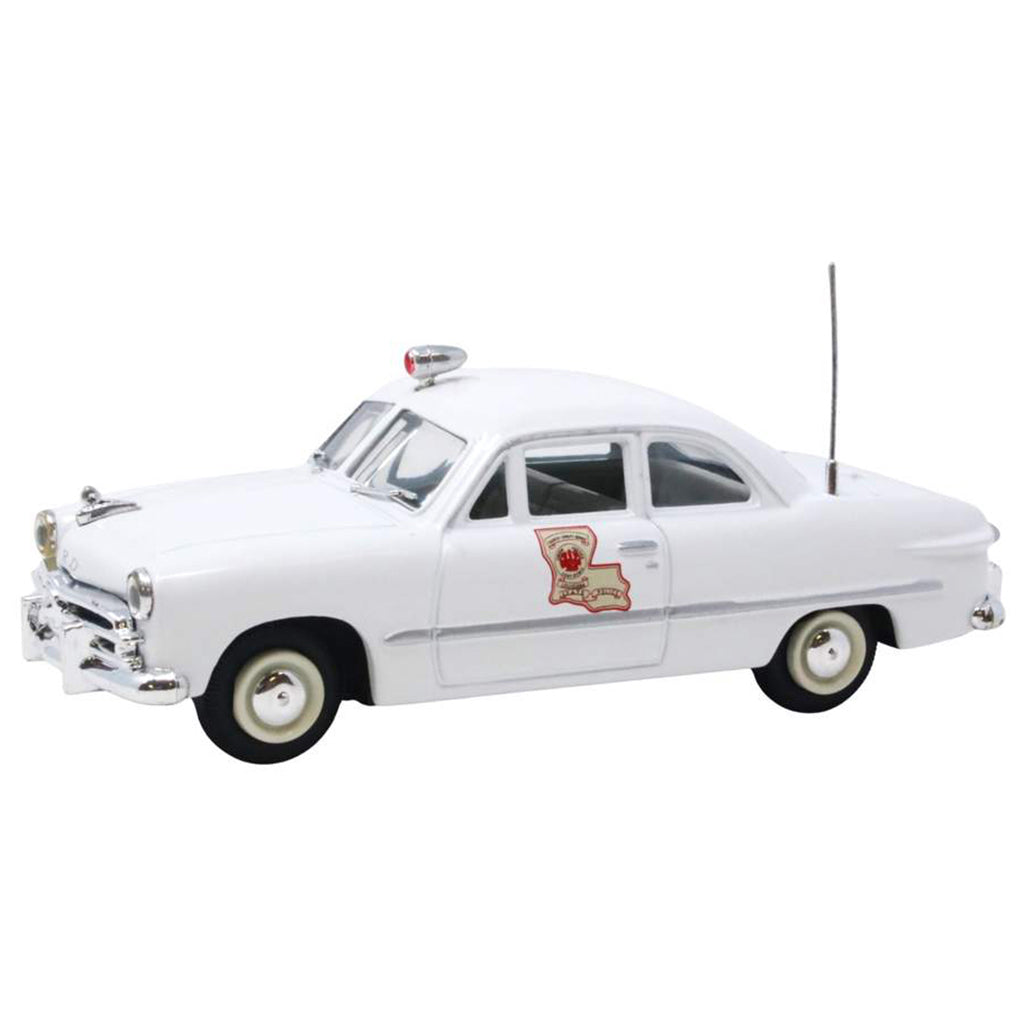 Model of a vintage police car with a state emblem on a white background
