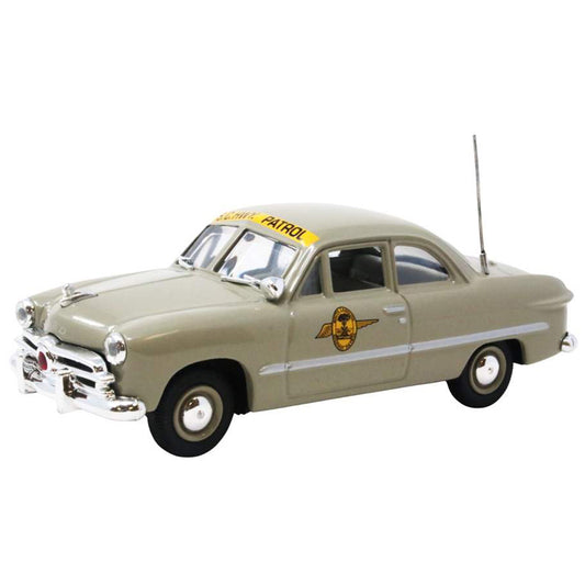 Model of a vintage police car with 'Patrol' sign on a white background