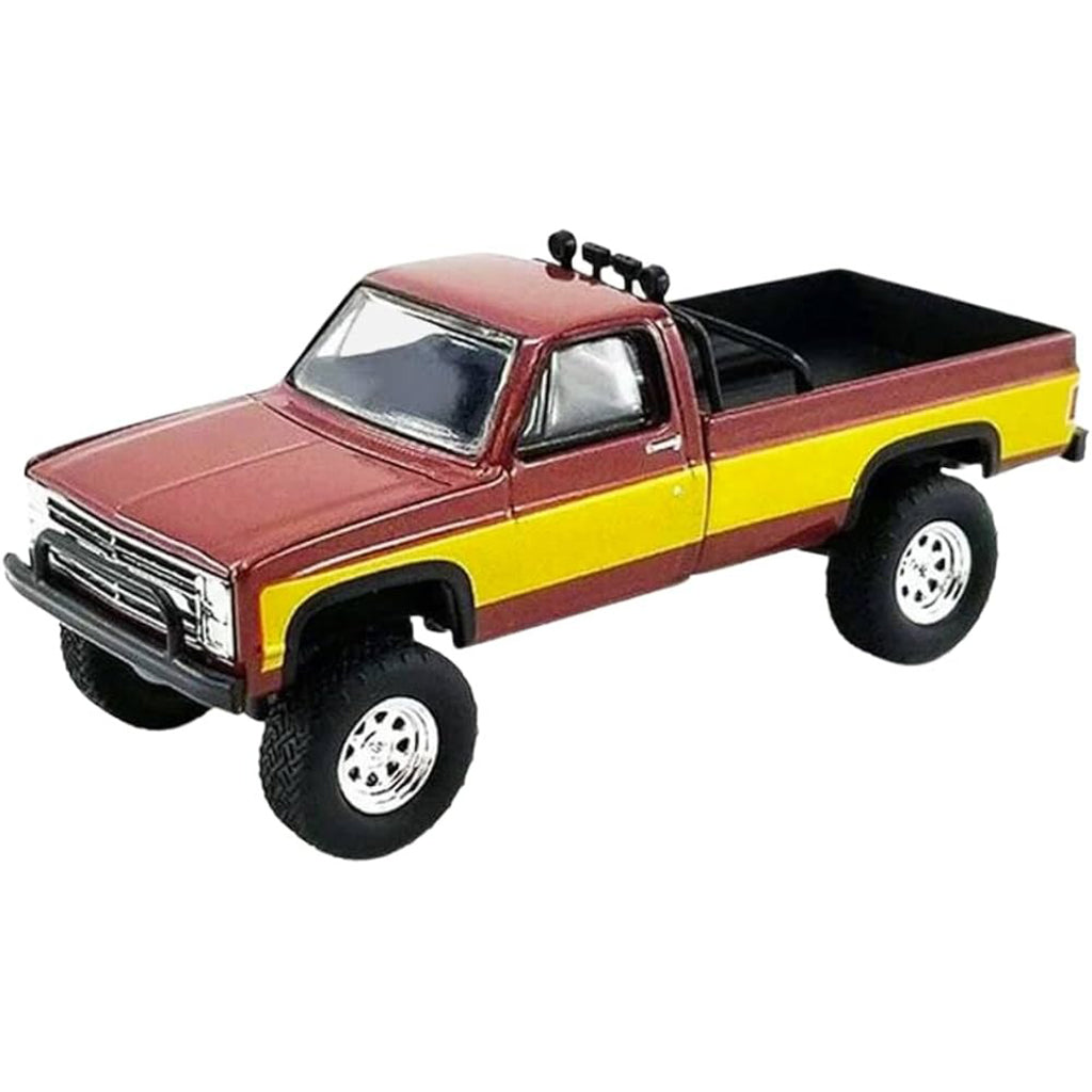 Model truck with red and yellow body on a white background