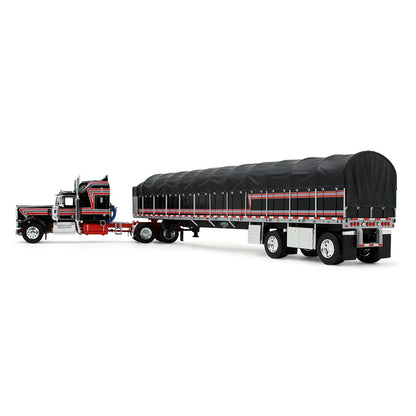 A die-cast model of a classic Kenworth semi-truck with a black and red cab, towing a long black canvas-covered trailer, shown on a plain white background.