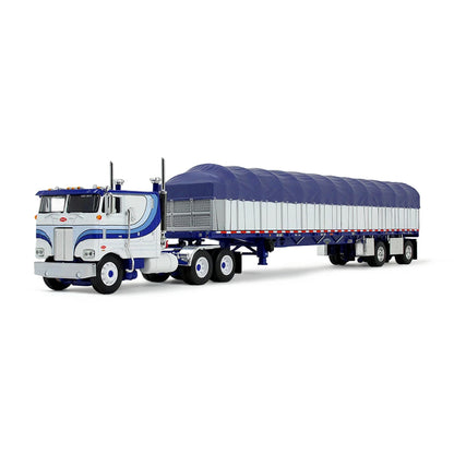 A die-cast model of a classic Peterbilt Cab-Over semi-truck with a White and blue cab, towing a long white with blue canvas-covered trailer, shown on a plain white background.