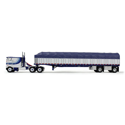 A die-cast model of a classic Peterbilt Cab-Over semi-truck with a White and blue cab, towing a long white with blue canvas-covered trailer, shown on a plain white background.