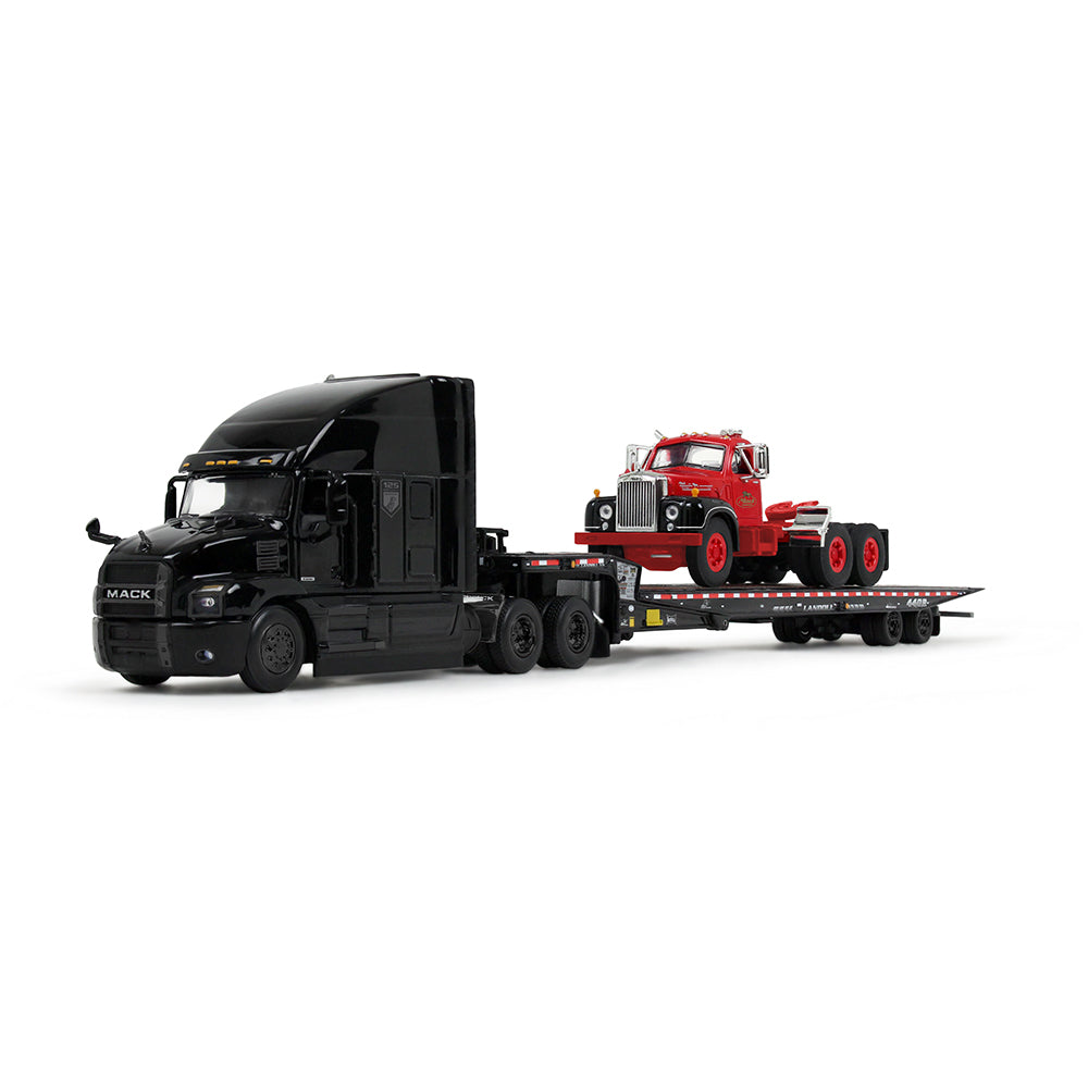 Model of a black truck towing a red truck on a white background