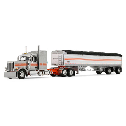 A diecast model of a Peterbilt semi-truck pulling a white grain trailer with orange stripes and a black tarp, on a white background.