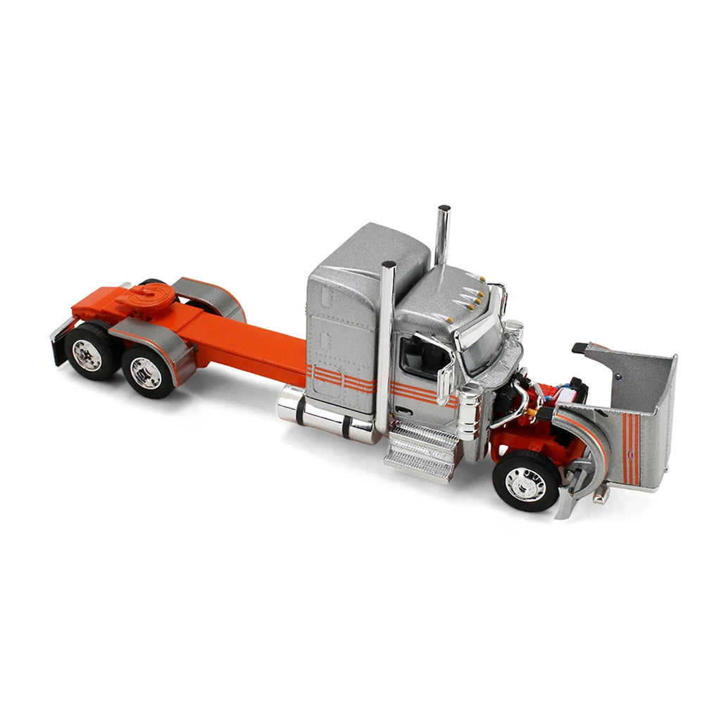A diecast model of a Peterbilt semi-truck pulling a white grain trailer with orange stripes and a black tarp, on a white background.