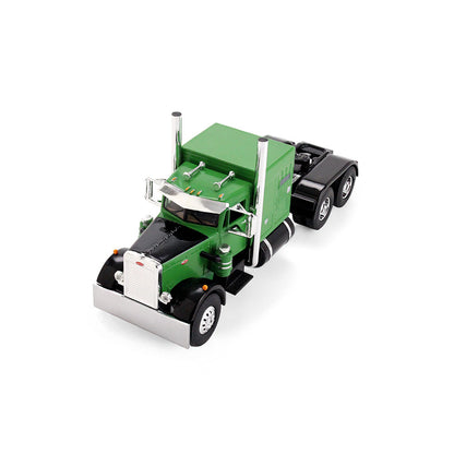 A green and black die-cast model semi-truck cab with chrome details, photographed on a seamless white background.