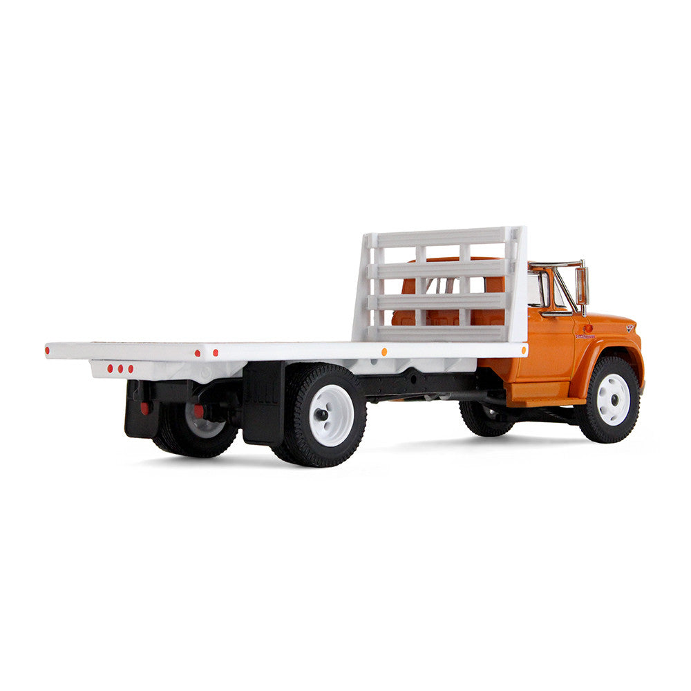 An orange GMC flatbed truck model with a white flatbed and white wheels, shown on a clean white background.