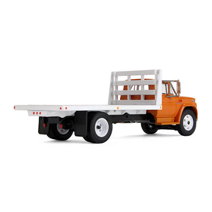 An orange GMC flatbed truck model with a white flatbed and white wheels, shown on a clean white background.