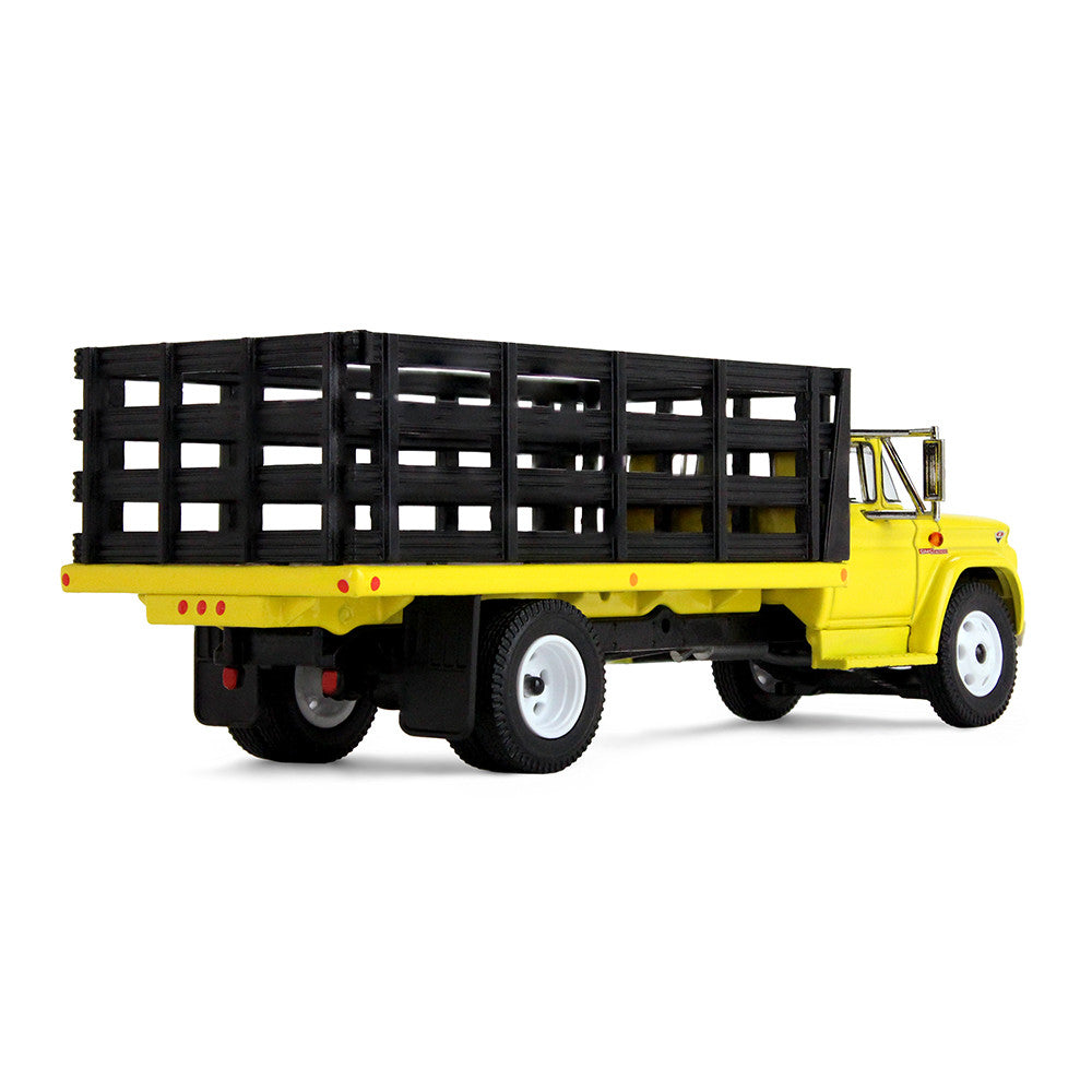 A yellow vintage GMC stake truck with a black slatted cargo bed on a clean white background.