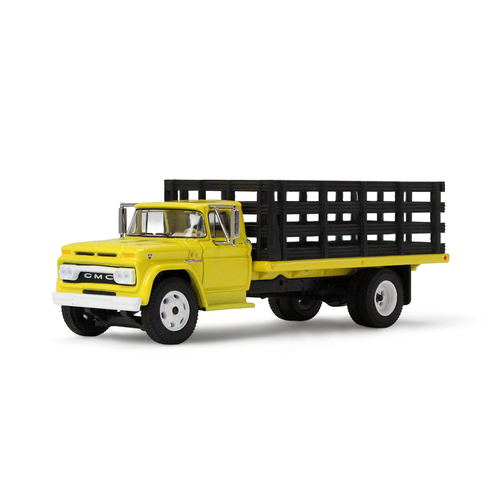 A yellow vintage GMC stake truck with a black slatted cargo bed on a clean white background.