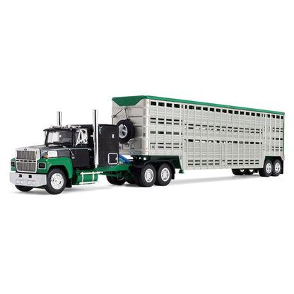 A die-cast model of a green and black semi-truck towing a silver livestock trailer with a green roof, shown on a plain white background.