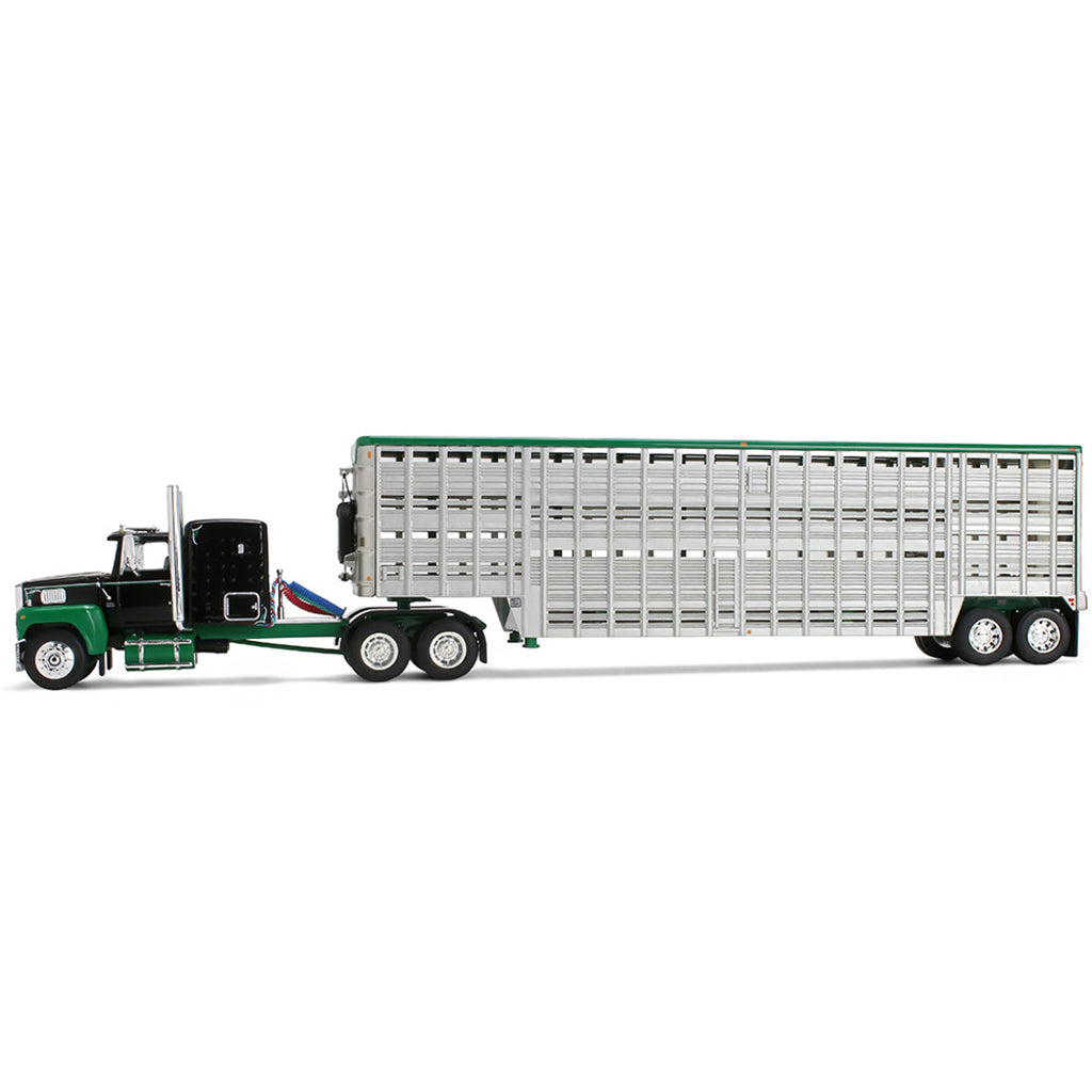 A die-cast model of a green and black semi-truck towing a silver livestock trailer with a green roof, shown on a plain white background.