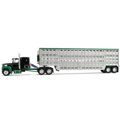 A die-cast model of a green and black semi-truck towing a silver livestock trailer with a green roof, shown on a plain white background.