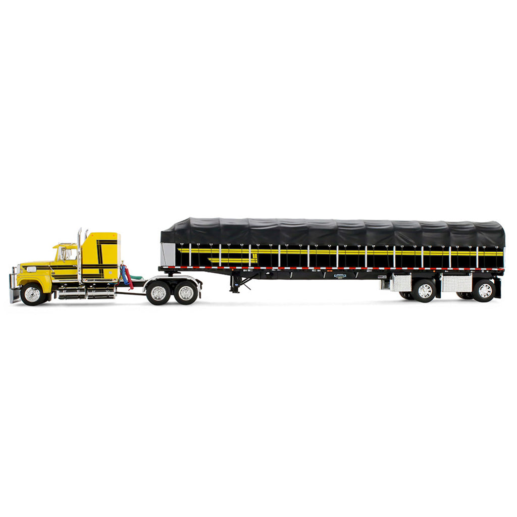 A model of a yellow semi-truck pulling a long black covered wagon trailer with yellow stripes, shown on a plain white background.
