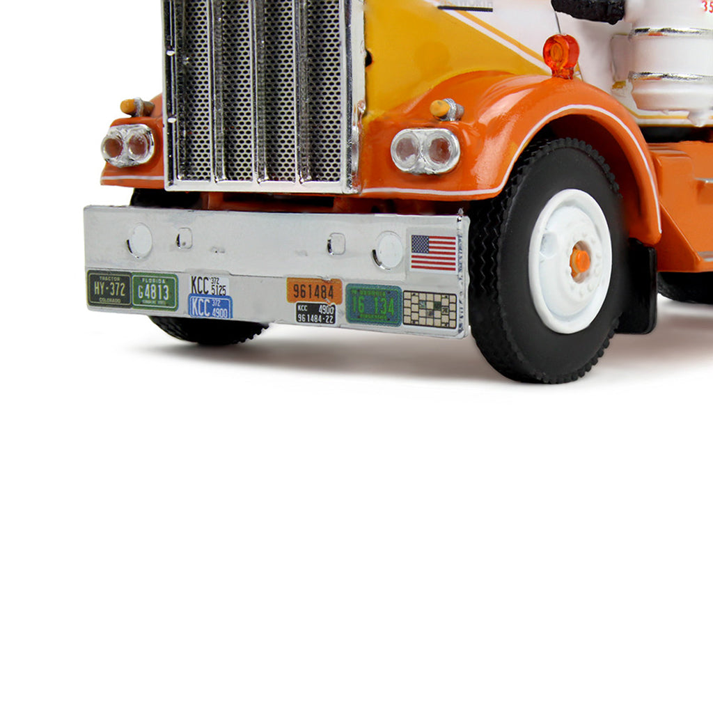 1:64th scale yellow, white, and orange model photographed on a clean white background