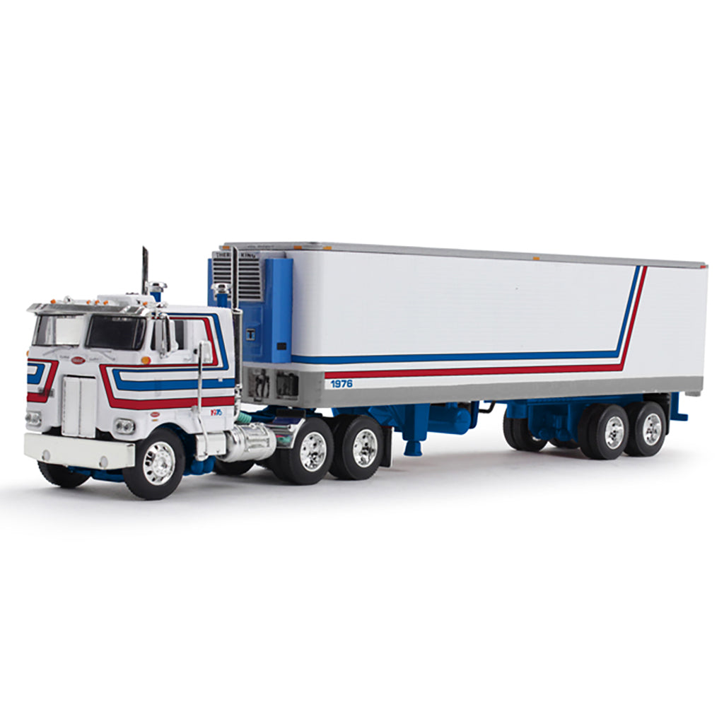 A die-cast model of a classic semi-truck with a white refrigerated trailer, featuring red and blue stripes, on a clean white background.