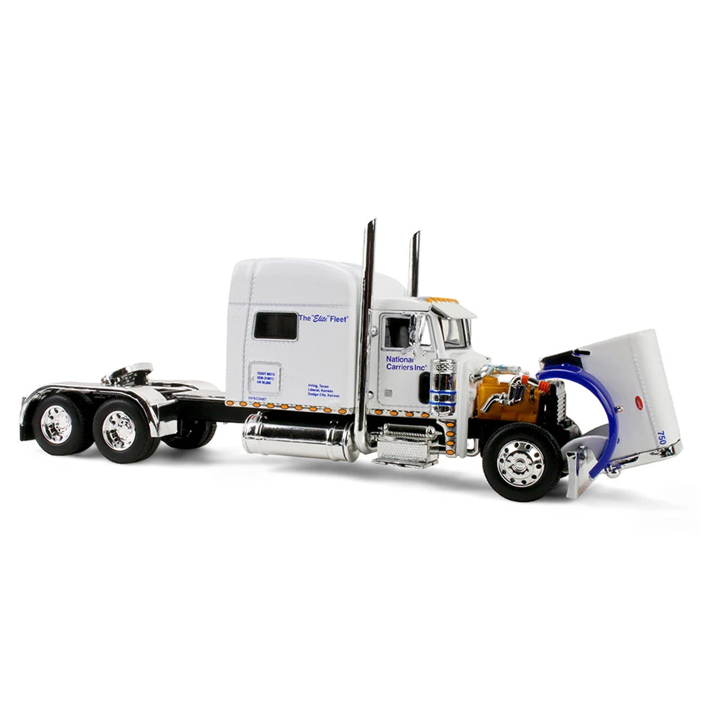 A white die-cast model semi-truck cab with chrome details, an exposed orange engine, and a blue air hose connected to the front wheel, photographed on a clean white background.