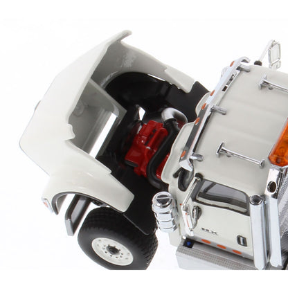 A close-up of a white toy semi-truck cab with an open hood showing a red engine compartment, black wheels, chrome details, and orange reflective accents on a white background.