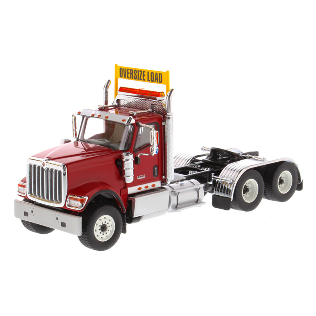1:50 Scale Diecast Model of a Red International HX520 Tandem-Axle Day Cab Tractor on a White Background