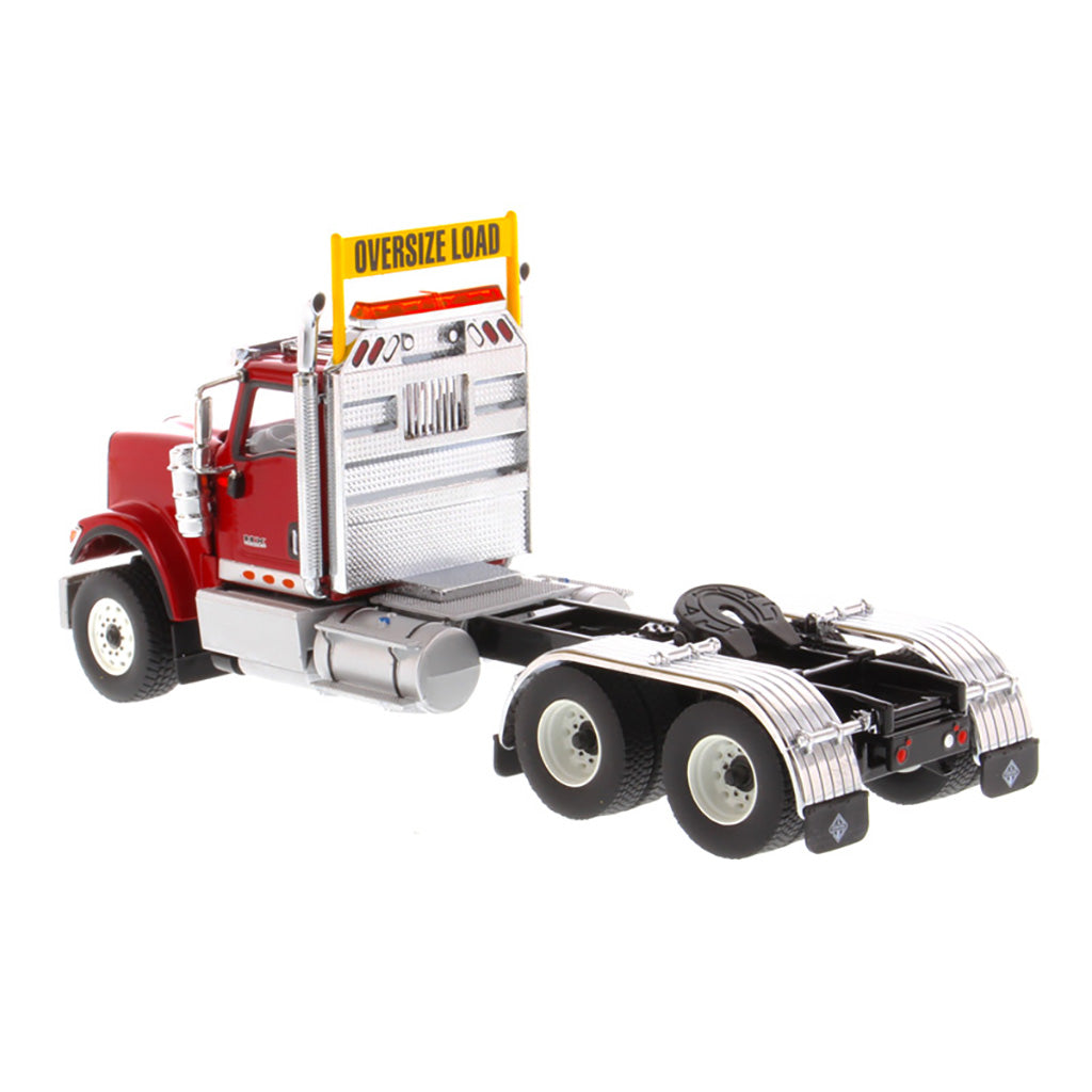 1:50 Scale Diecast Model of a Red International HX520 Tandem-Axle Day Cab Tractor on a White Background