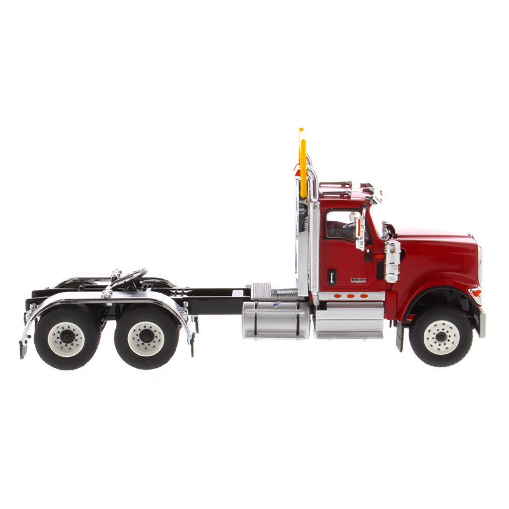 1:50 Scale Diecast Model of a Red International HX520 Tandem-Axle Day Cab Tractor on a White Background
