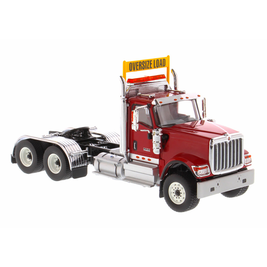 1:50 Scale Diecast Model of a Red International HX520 Tandem-Axle Day Cab Tractor on a White Background