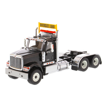 1:50 Scale Diecast Model of a Black International HX520 Tandem-Axle Day Cab Tractor on a White Background