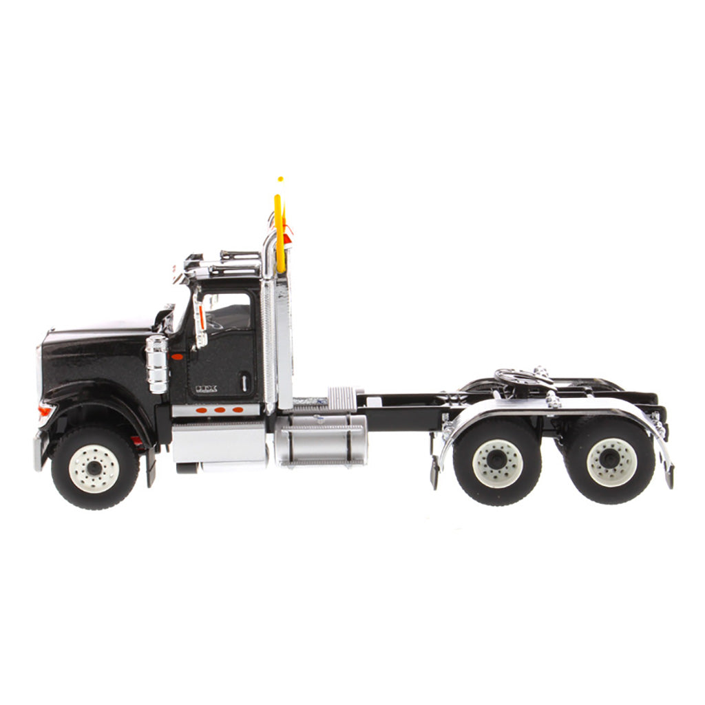 1:50 Scale Diecast Model of a Black International HX520 Tandem-Axle Day Cab Tractor on a White Background