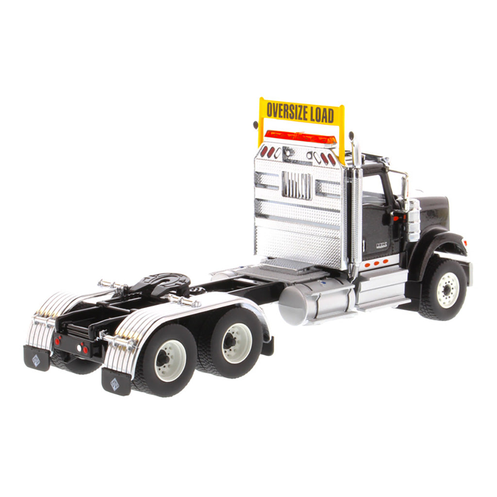 1:50 Scale Diecast Model of a Black International HX520 Tandem-Axle Day Cab Tractor on a White Background