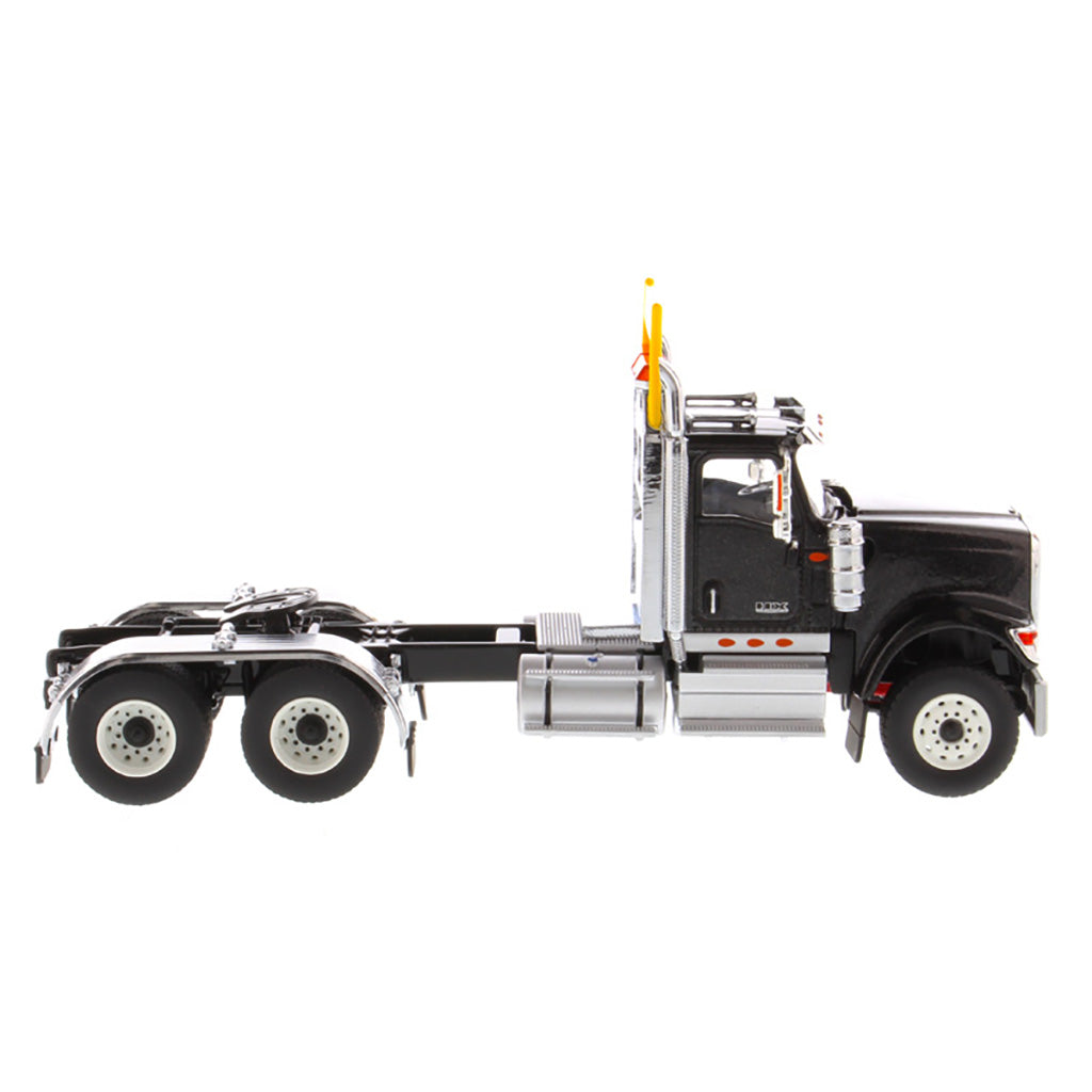 1:50 Scale Diecast Model of a Black International HX520 Tandem-Axle Day Cab Tractor on a White Background