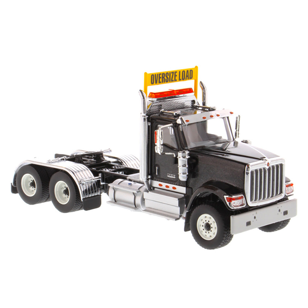 1:50 Scale Diecast Model of a Black International HX520 Tandem-Axle Day Cab Tractor on a White Background