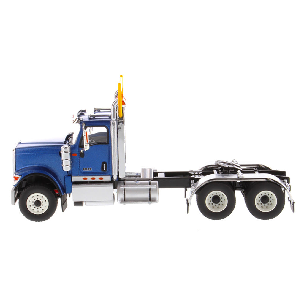 1:50 Scale Diecast Model of a Blue International HX520 Tandem-Axle Day Cab Tractor on a White Background