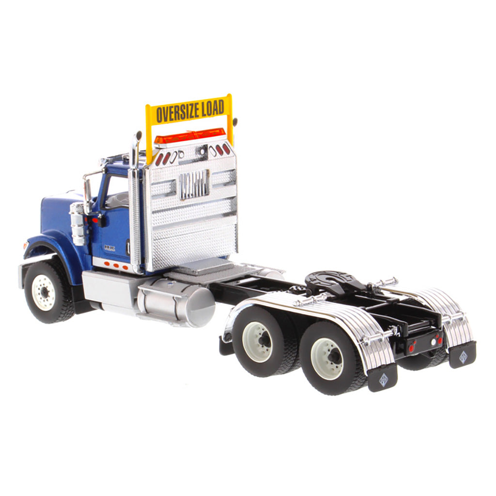1:50 Scale Diecast Model of a Blue International HX520 Tandem-Axle Day Cab Tractor on a White Background