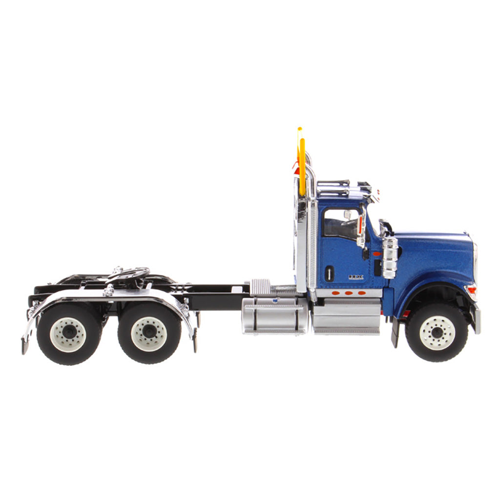 1:50 Scale Diecast Model of a Blue International HX520 Tandem-Axle Day Cab Tractor on a White Background