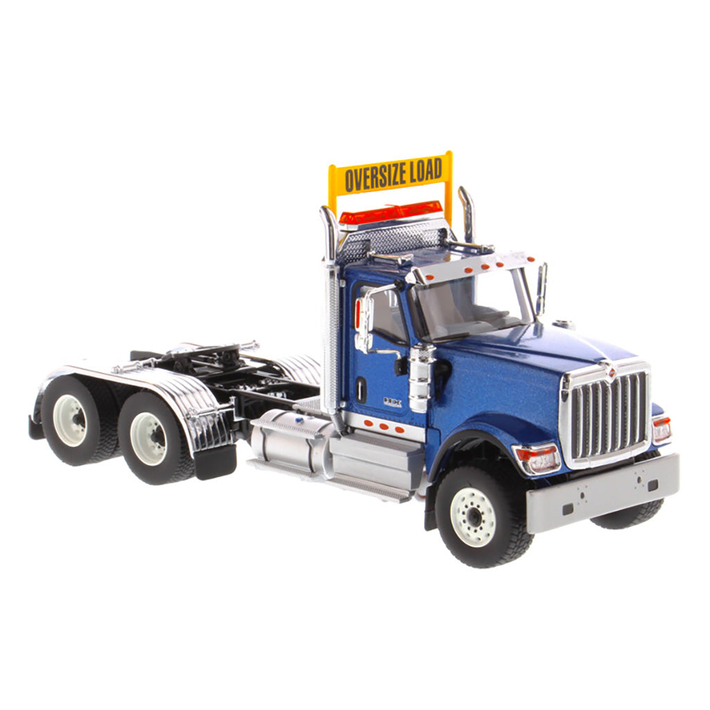 1:50 Scale Diecast Model of a Blue International HX520 Tandem-Axle Day Cab Tractor on a White Background