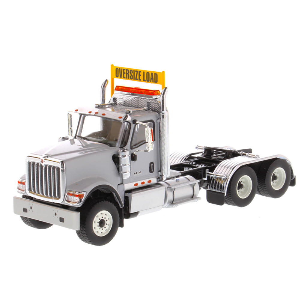 1:50 Scale Diecast Model of a Light Gray International HX520 Tandem-Axle Day Cab Tractor on a White Background