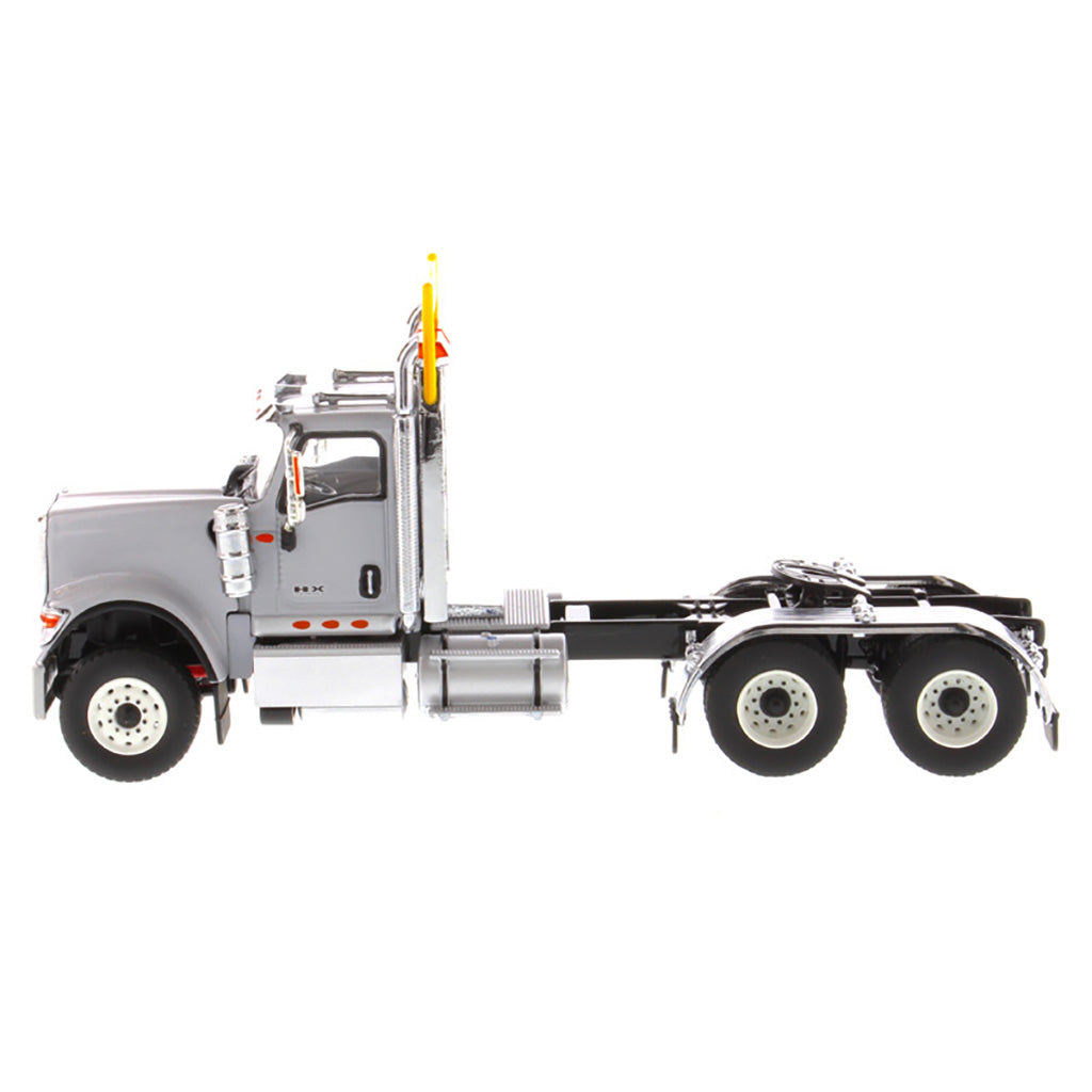 1:50 Scale Diecast Model of a Light Gray International HX520 Tandem-Axle Day Cab Tractor on a White Background