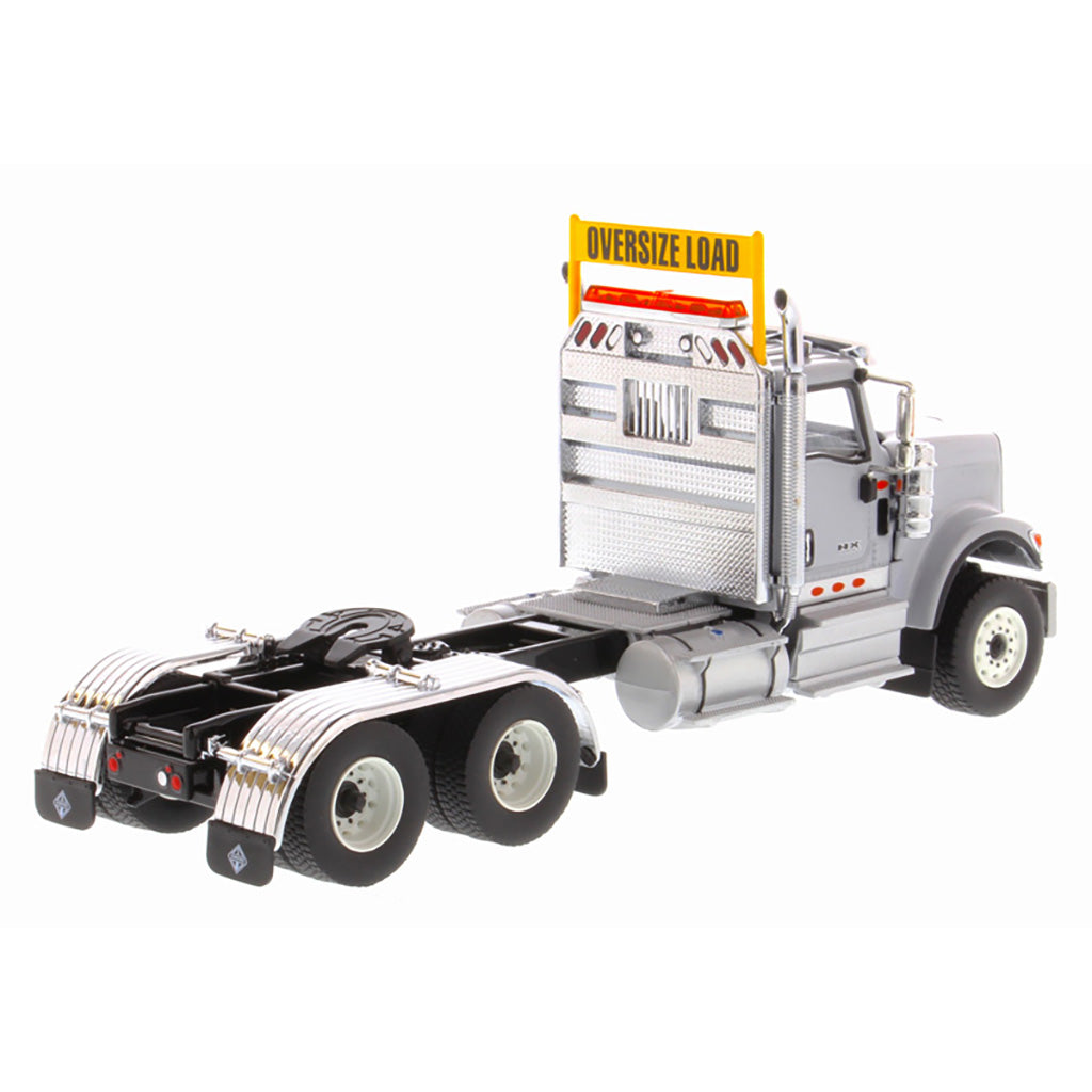 1:50 Scale Diecast Model of a Light Gray International HX520 Tandem-Axle Day Cab Tractor on a White Background