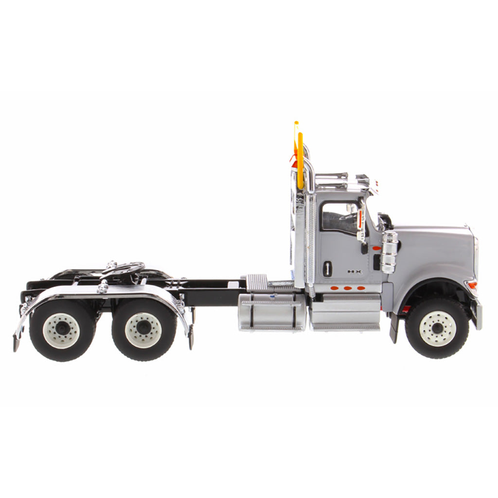 1:50 Scale Diecast Model of a Light Gray International HX520 Tandem-Axle Day Cab Tractor on a White Background