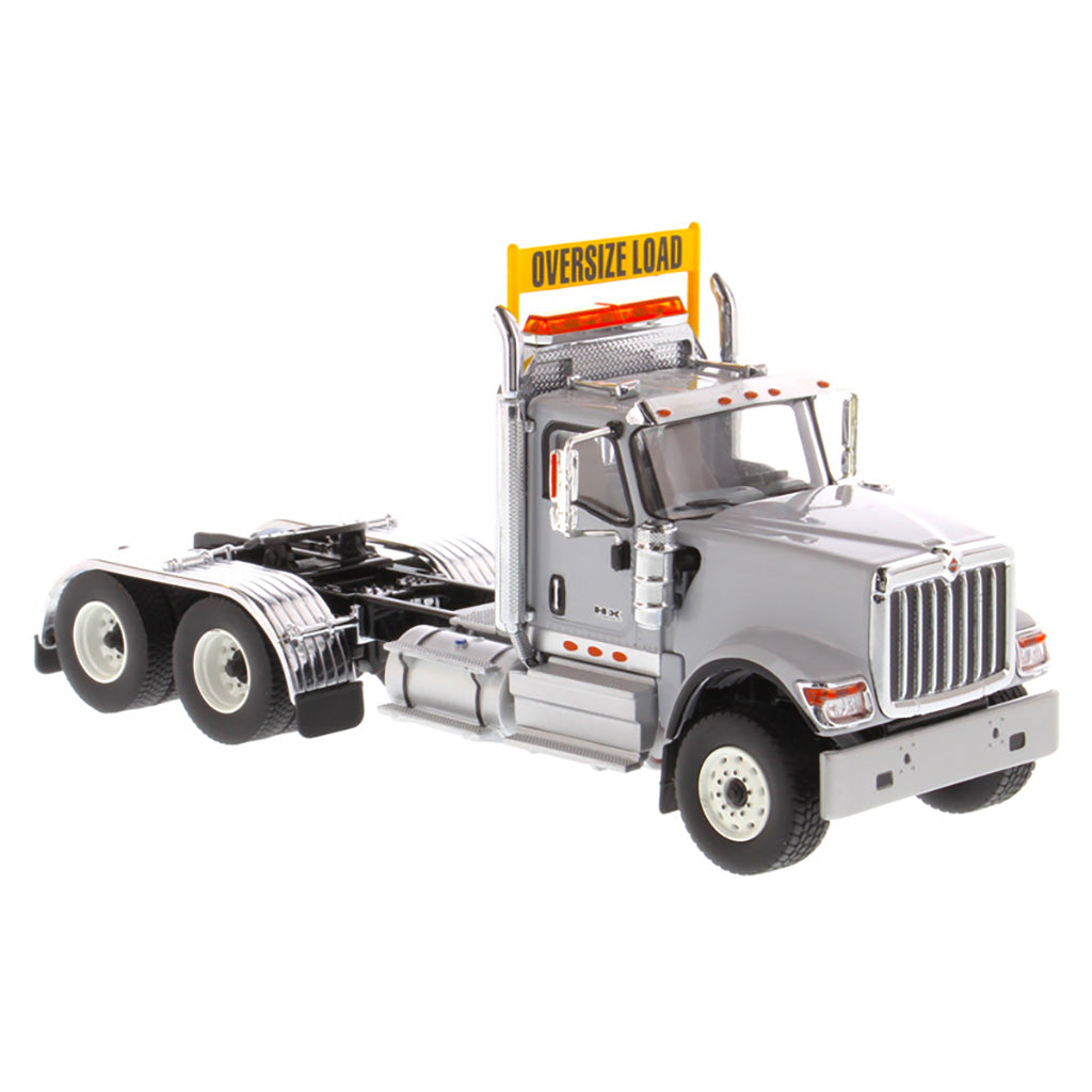 1:50 Scale Diecast Model of a Light Gray International HX520 Tandem-Axle Day Cab Tractor on a White Background
