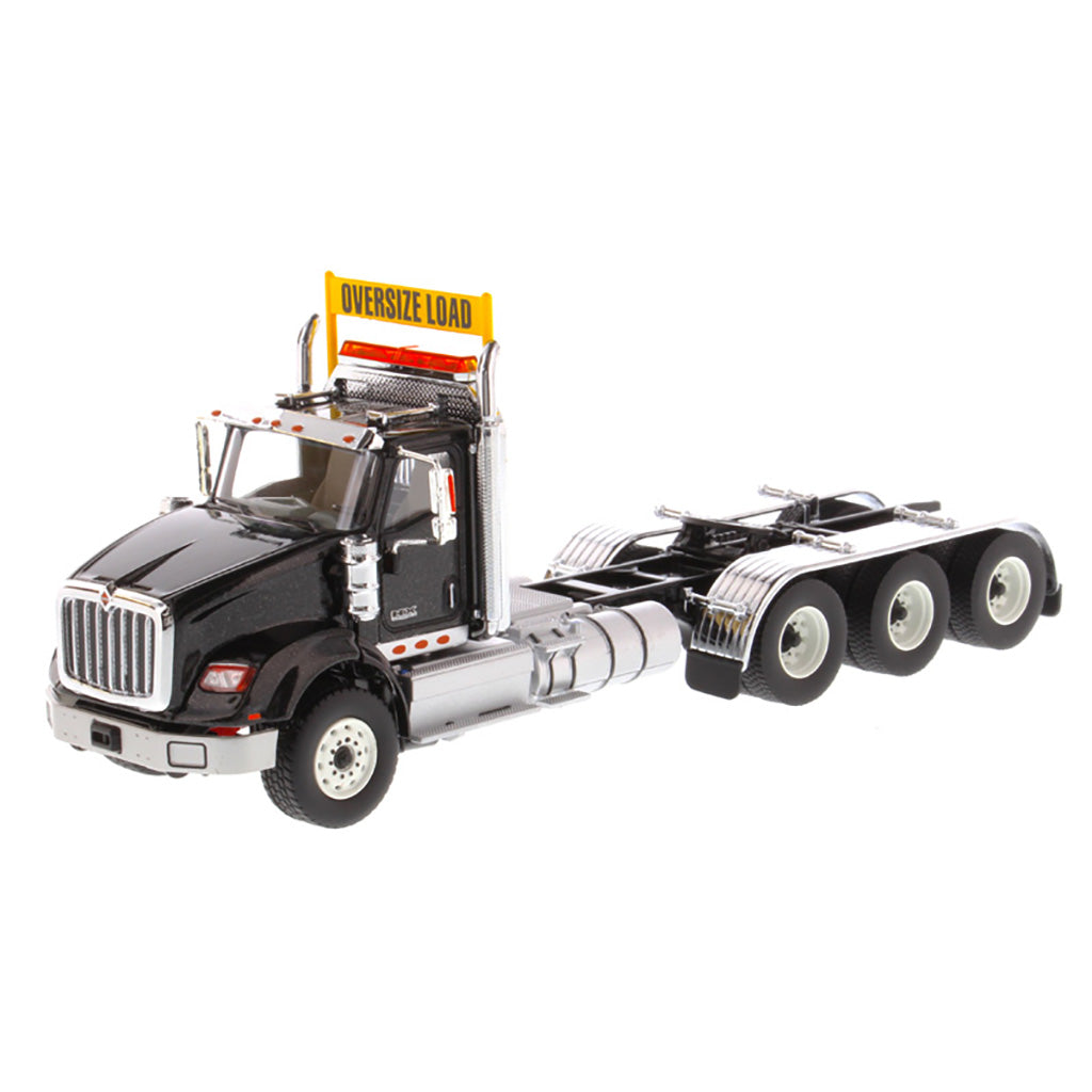 1:50 Scale Diecast Model of a Metallic Black International HX620 Tri-Axle Day Cab Tractor on a White Background